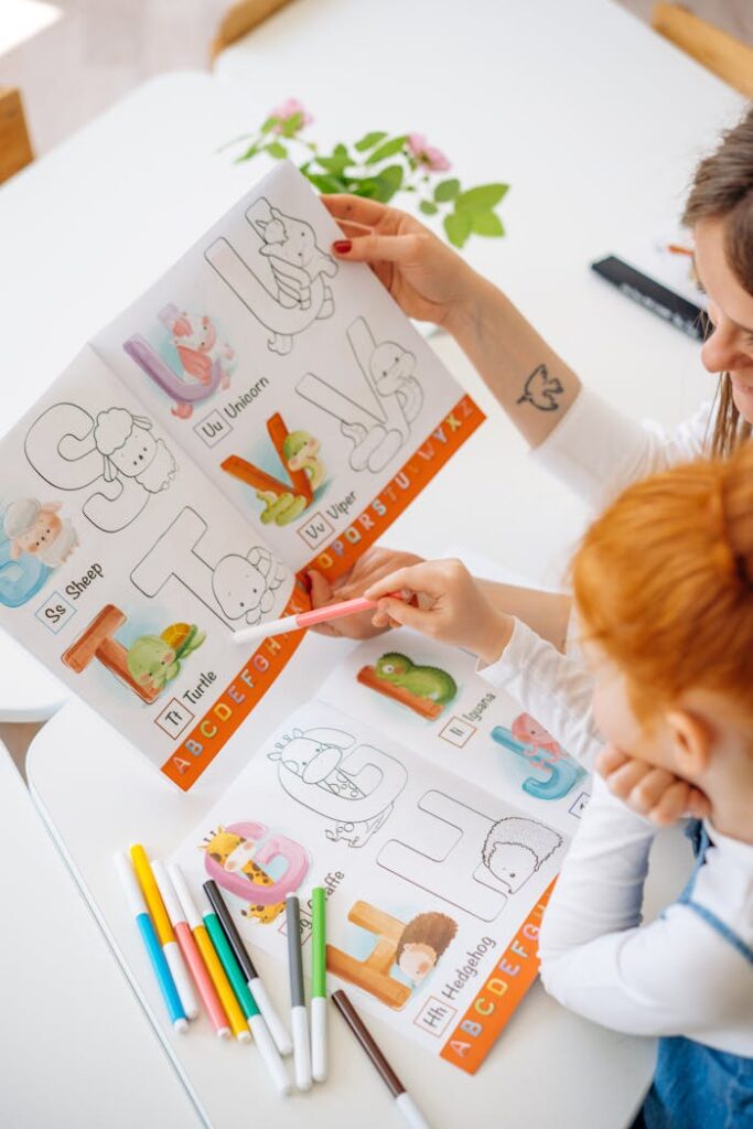 A child and adult learning alphabets using a colorful illustrated book and markers.